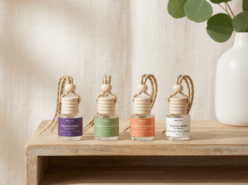 Collection of refillable car diffusers in multiple scents displayed on wooden shelf representing long-lasting and customizable car fragrance options