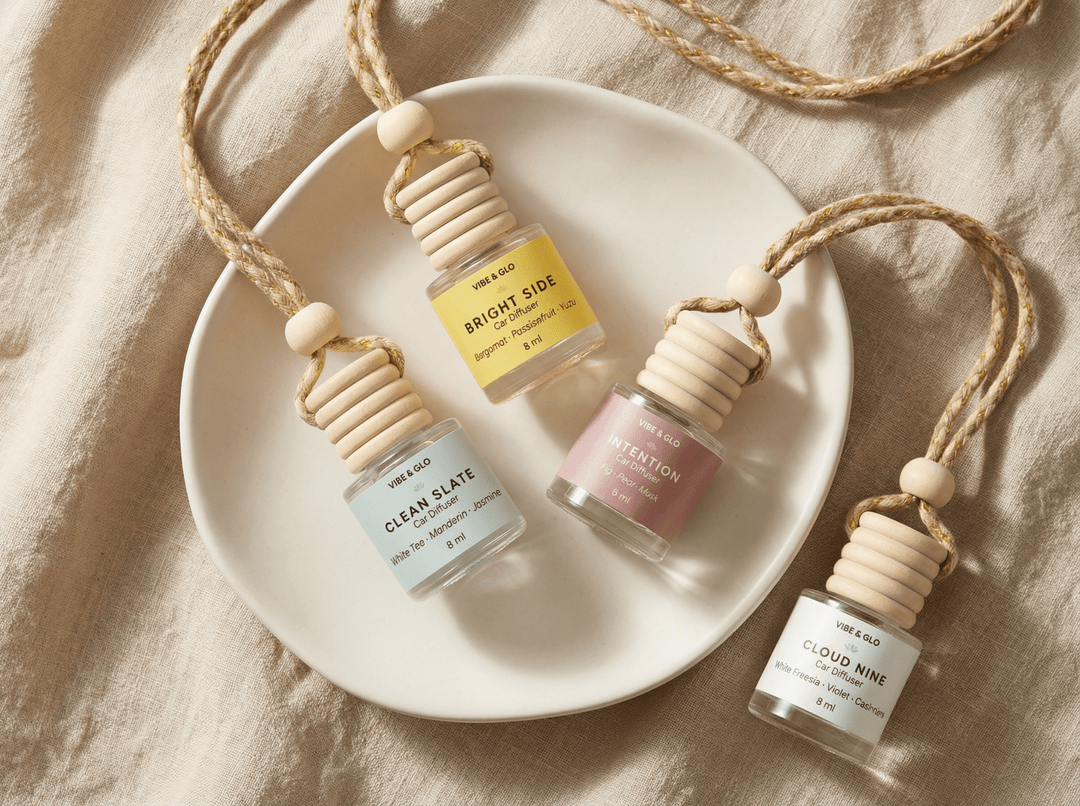 Flatlay of refillable car diffusers in multiple scents on a neutral background representing non-toxic car air freshener alternatives and long-lasting car fragrance