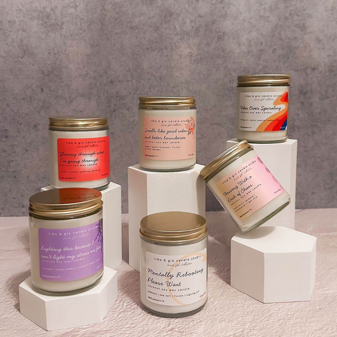 Vibe & Glo Candle Studio Inner Glo Collection featuring multiple coconut soy wax candles on white pedestals against a grey backdrop.