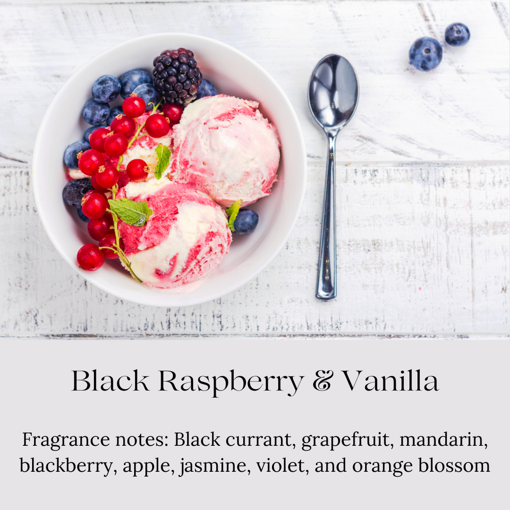 
                      
                        A white bowl of raspberry swirl ice cream is garnished with fresh blackberries, blueberries, red currants, and a sprig of mint. The bowl is placed on a whitewashed wooden surface next to a silver spoon. Below the image, text reads "Black Raspberry & Vanilla" with fragrance notes including black currant, grapefruit, mandarin, blackberry, apple, jasmine, violet, and orange blossom.
                      
                    