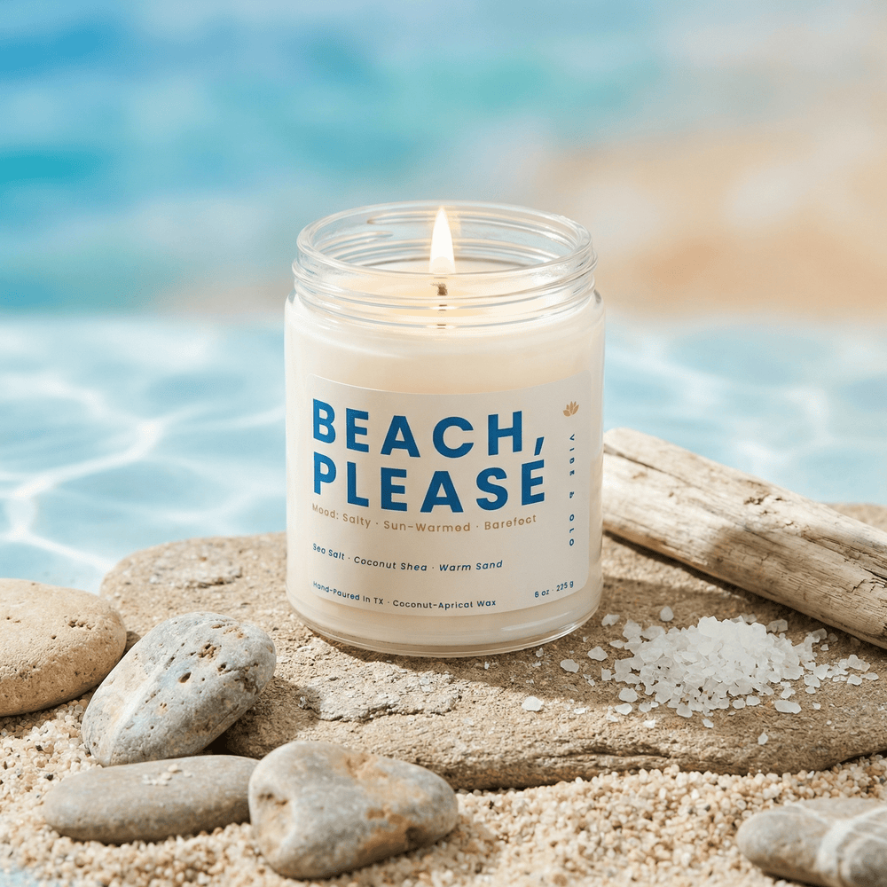 Beach scented candle with sea salt and driftwood styled near water for a fresh coastal atmosphere