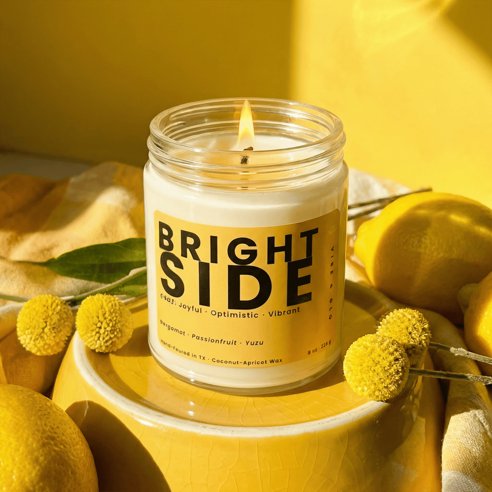 Bright Side candle styled with yellow florals and lemons creating a cheerful uplifting home fragrance for a happy vibrant space