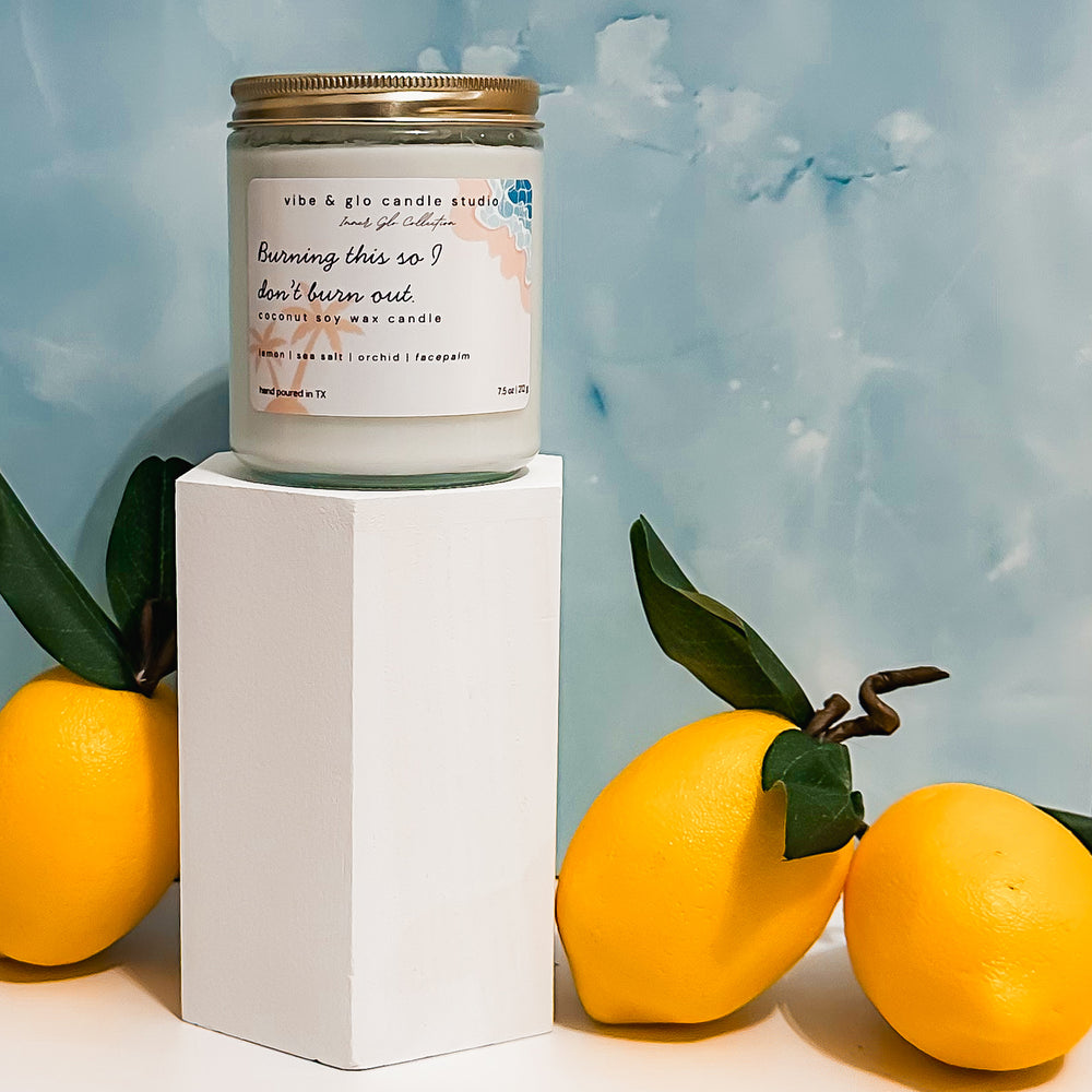 Burning this so I don’t burn out coconut soy wax candle with lemon, sea salt, and orchid. Styled with lemons against a blue sky-inspired backdrop.