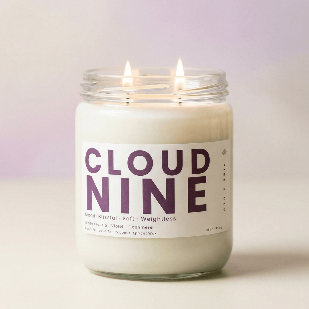 Cloud Nine 2-wick candle glowing on soft neutral background, clean fresh candle with light floral scent