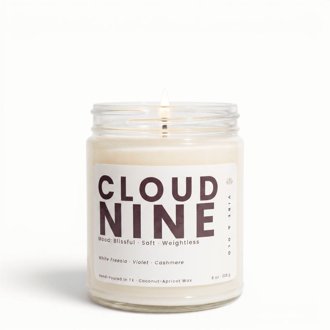 Cloud Nine freesia violet cashmere candle in glass jar with lit wick, soft clean coconut apricot wax candle for a light airy home fragrance