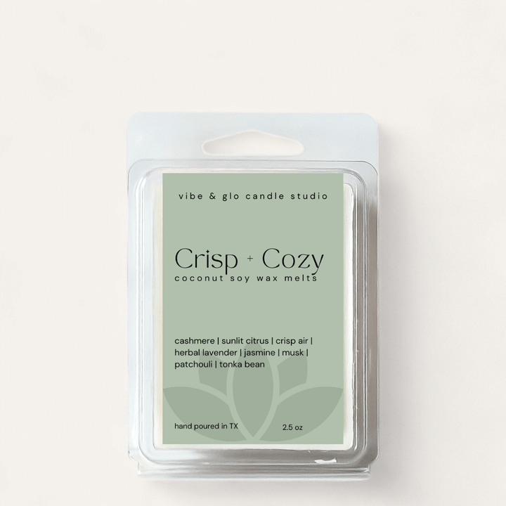 Crisp + Cozy coconut soy wax melts in a clear clamshell packaging, featuring seasonal scents for a warm ambiance.