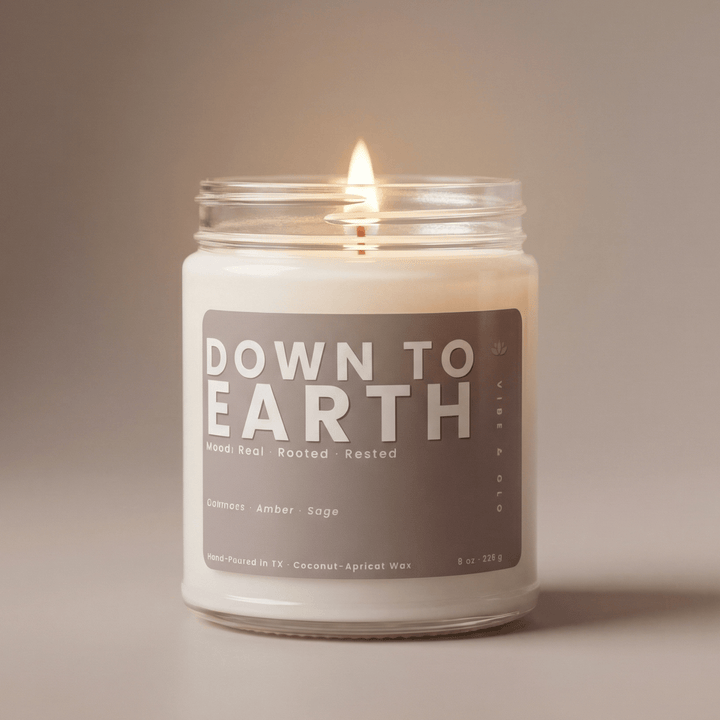 Down to Earth candle in a clean minimal product shot with soft neutral tones representing a grounding home fragrance