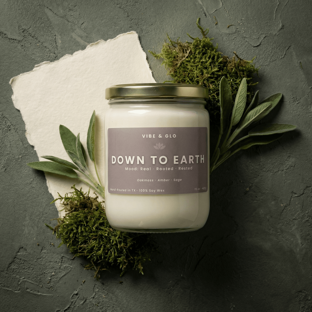 down to earth double wick soy candle with sage leaves and moss earthy aesthetic grounding amber sage candle vibe and glo
