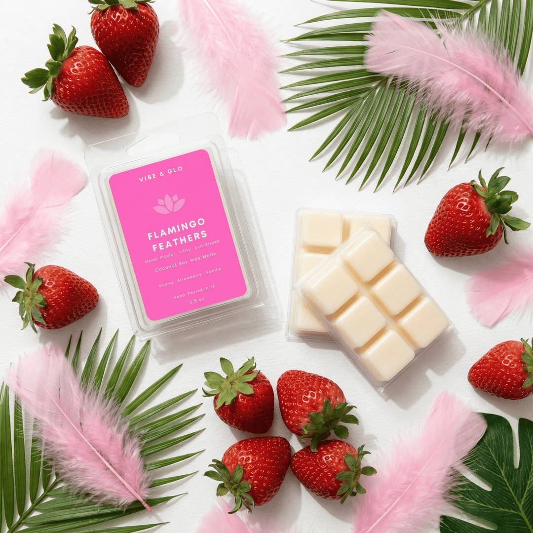 Flamingo Feathers wax melts with strawberries, pink feathers, and tropical leaves in playful summer flatlay