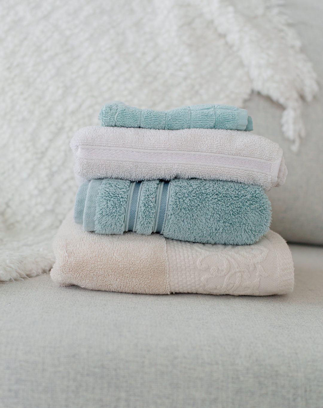 clean folded towels placed on a couch