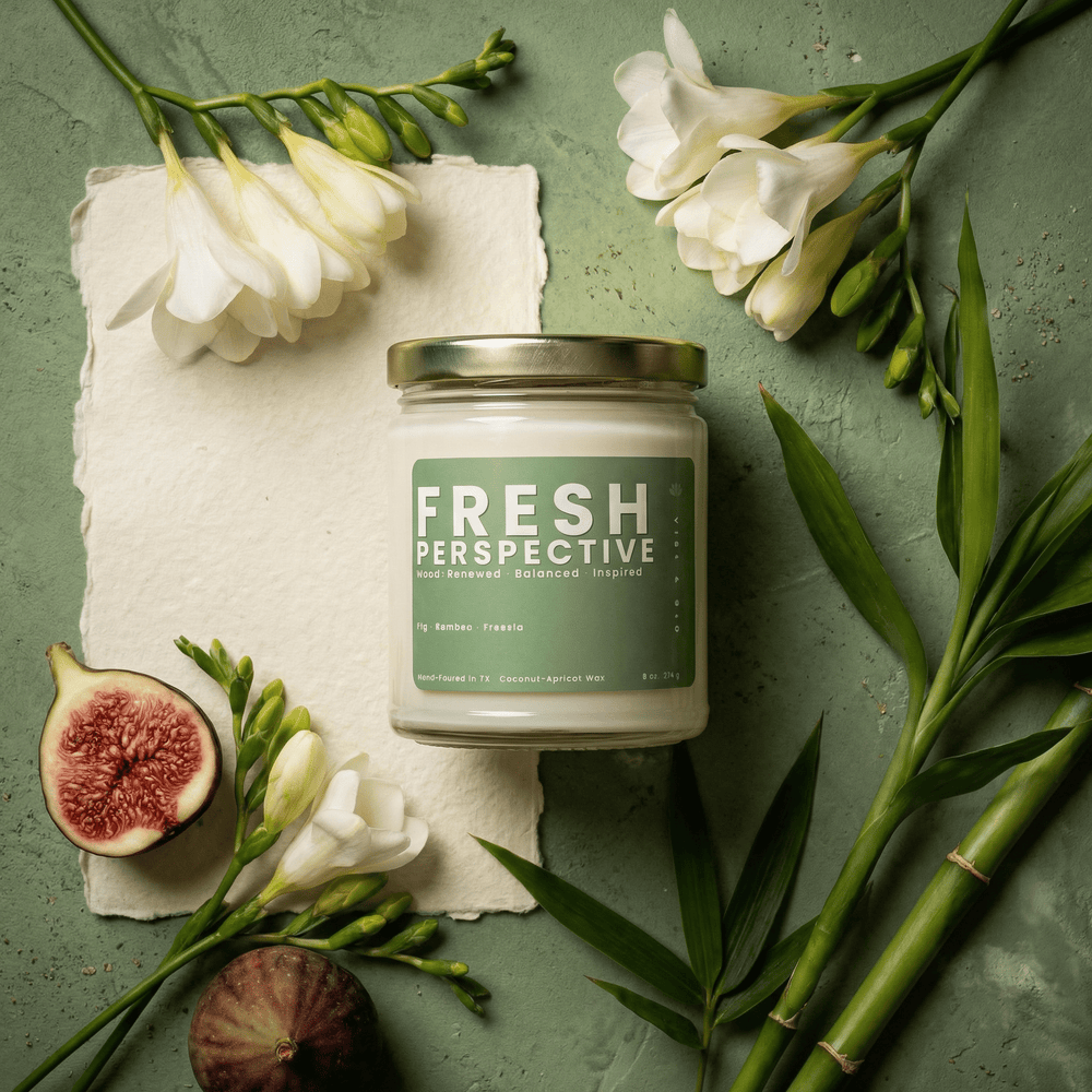 Fresh Perspective jar candle styled with fig, bamboo, and white florals, clean fresh scent with freesia in coconut apricot wax