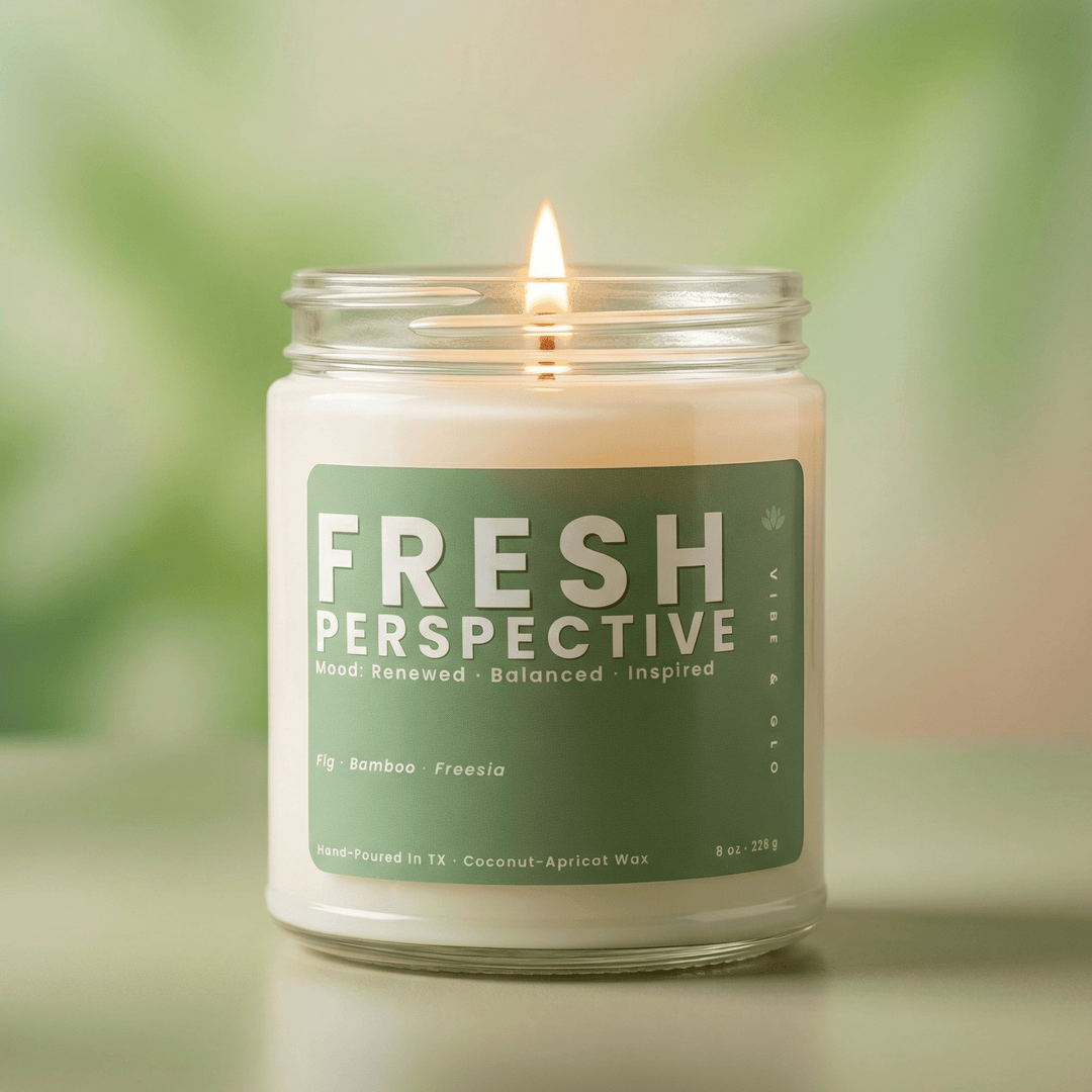 Fresh Perspective clean fresh candle burning in soft green setting, light airy scent with fig bamboo and freesia