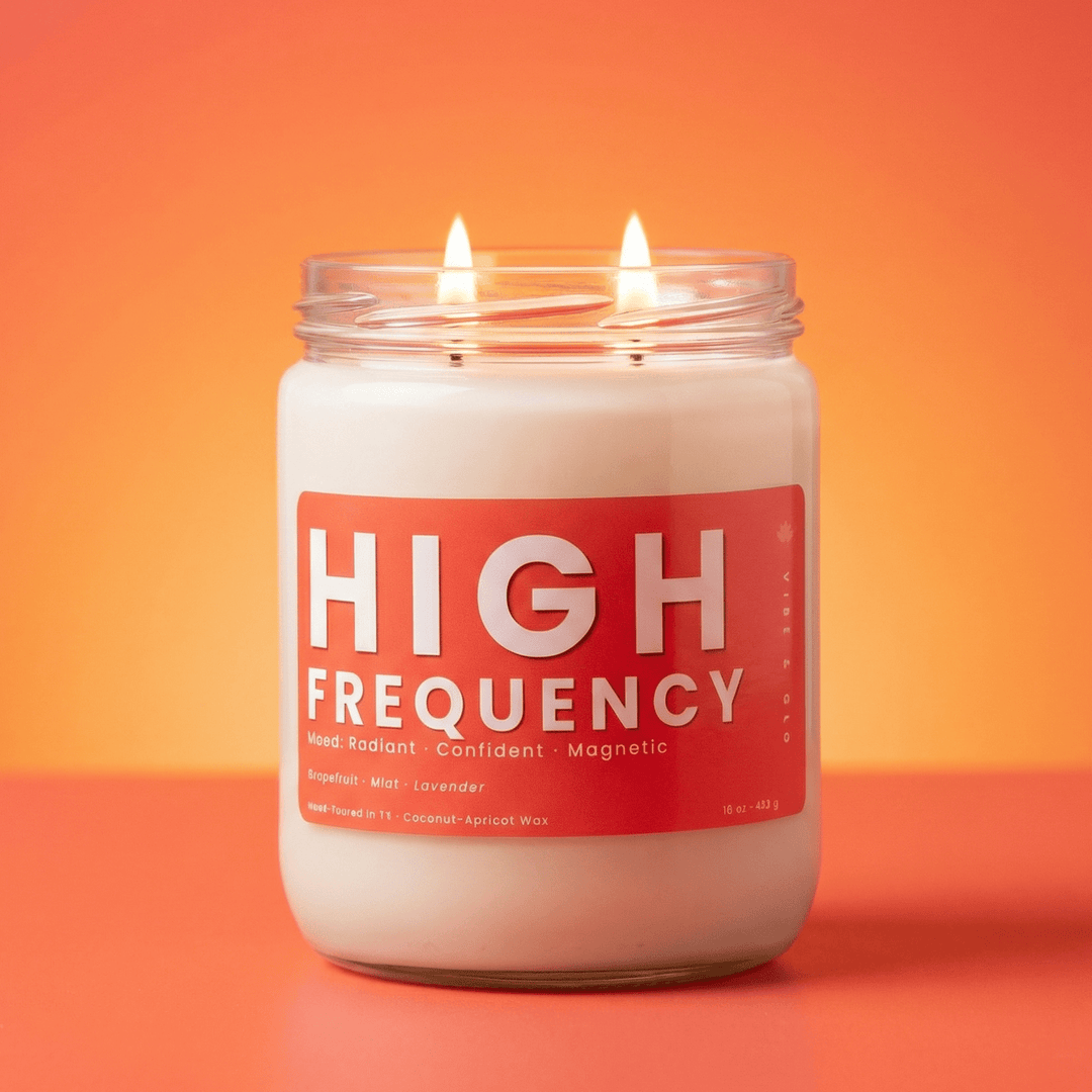 High Frequency 2-wick soy candle with two cotton wicks on a warm orange gradient background, clean modern product hero image