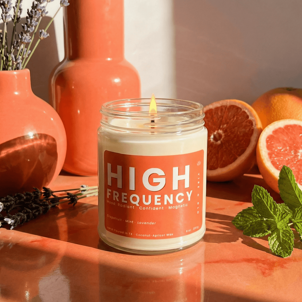 High Frequency citrus candle with grapefruit mint and lavender styled in a bright energizing home fragrance setting