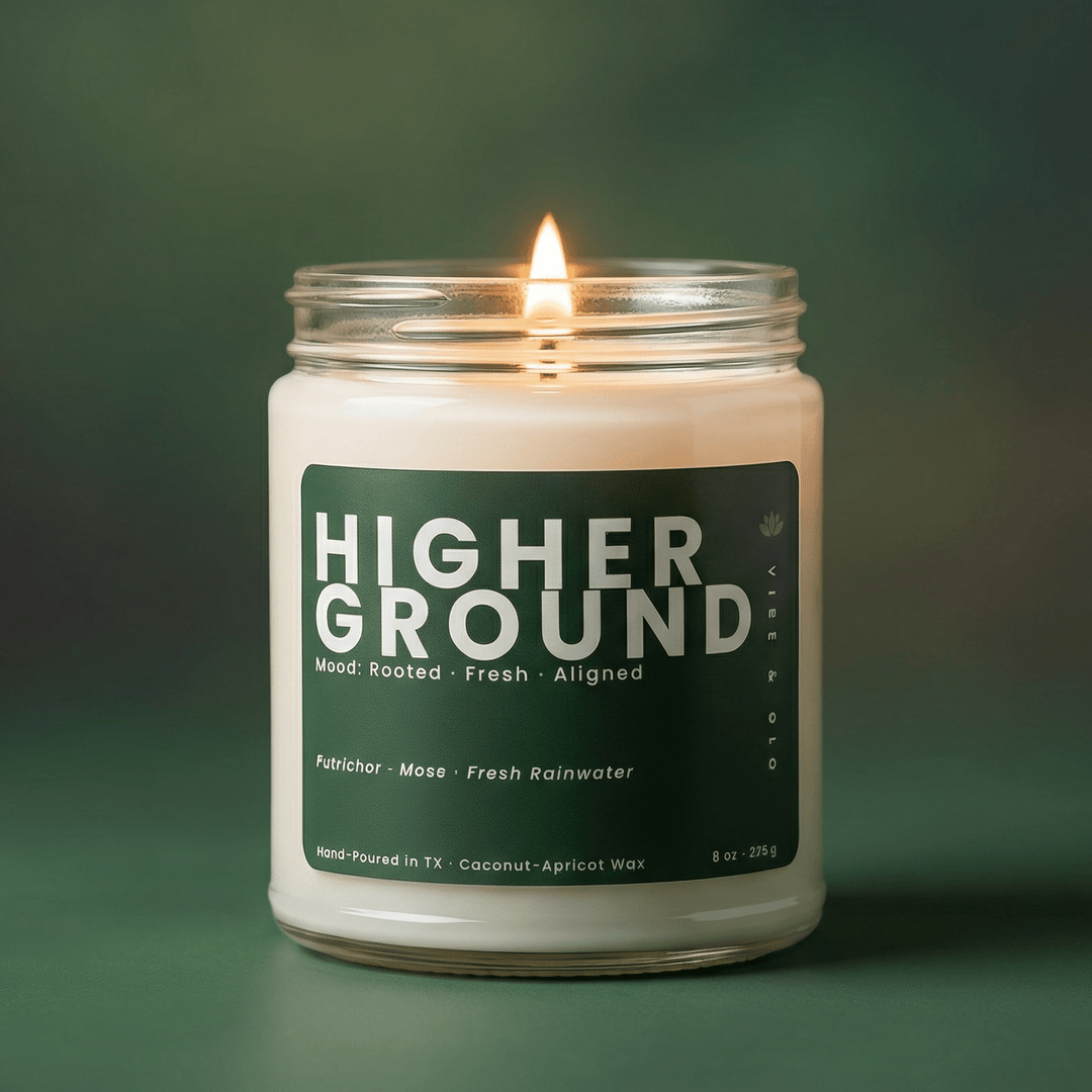 Higher Ground single wick jar candle burning against green background, fresh petrichor moss rainwater scent in coconut apricot wax