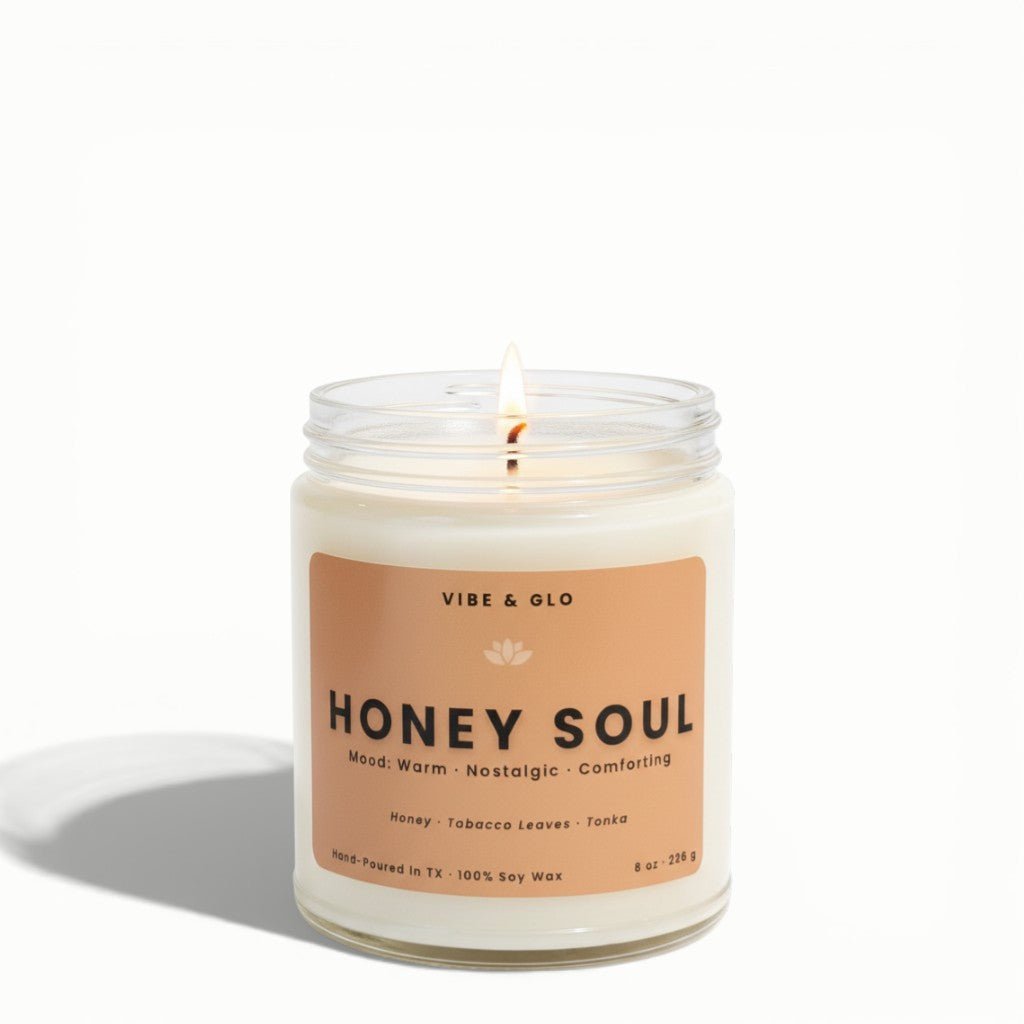 Honey Soul 8 oz honey tobacco tonka soy candle in clear glass jar lit on white background
