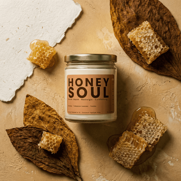 Honey Soul candle styled with honeycomb and dried leaves in a warm flatlay creating a cozy gourmand home fragrance aesthetic