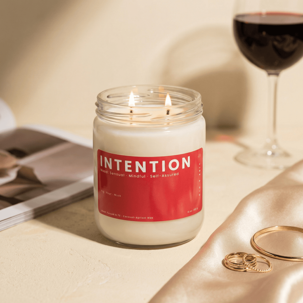 Intention candle with wine glass and gold jewelry, romantic sensual candle with fig pear and musk notes for evening ambiance