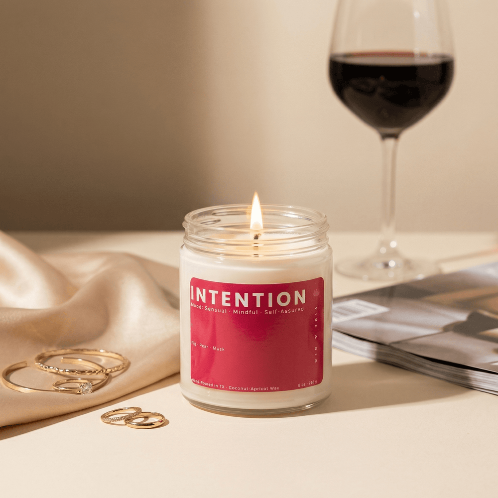 Intention candle styled with wine glass and gold jewelry, sensual fig pear musk scent creating a soft elevated self care mood