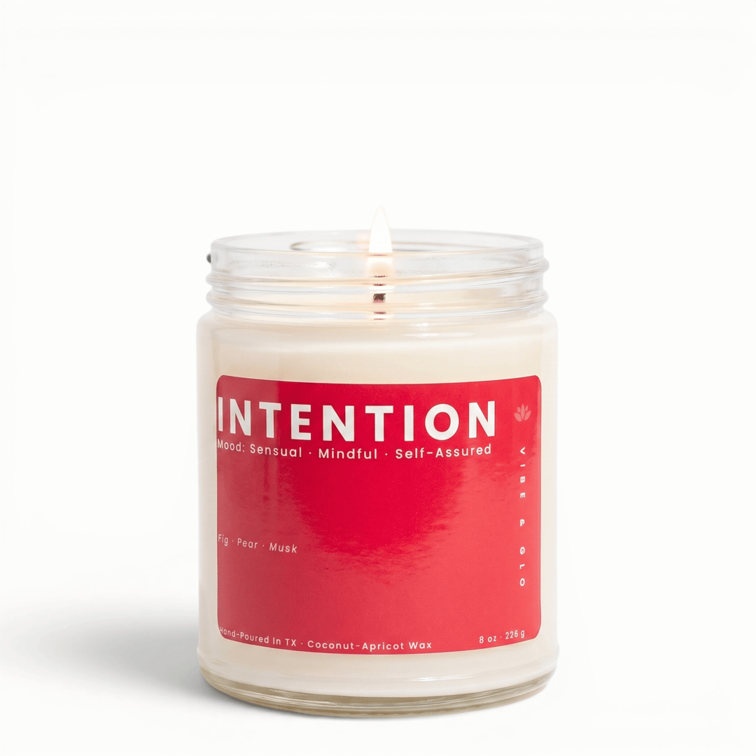 Intention fig pear musk candle in glass jar with lit wick, clean coconut apricot wax candle for a soft sensual home fragrance
