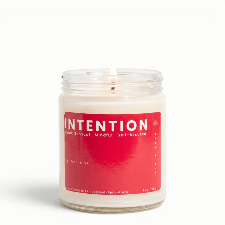 Intention fig pear musk candle in glass jar with lit wick, clean coconut apricot wax candle for a soft sensual home fragrance