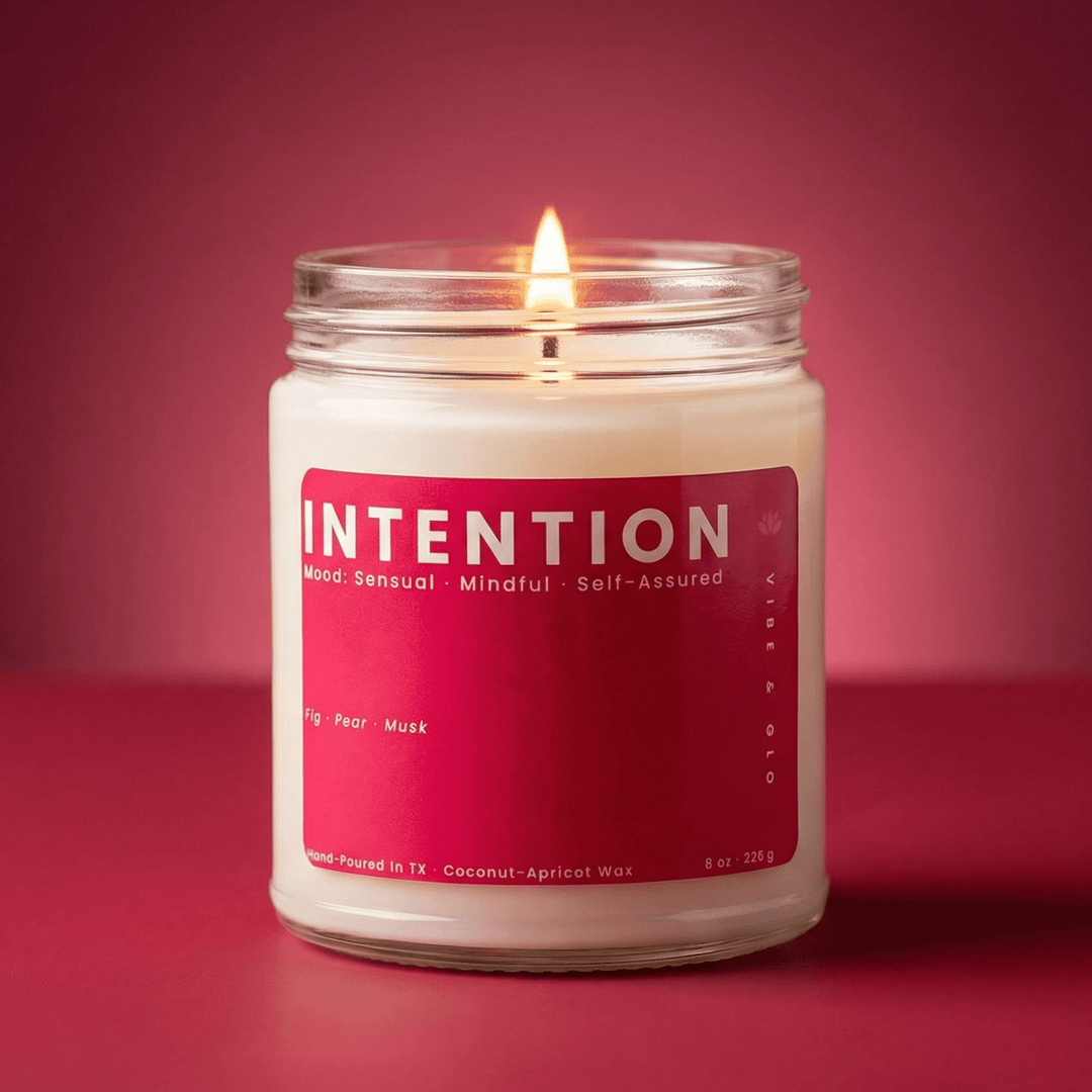 Intention sensual scented candle burning in bold pink setting, soft fig pear and musk fragrance in coconut apricot wax