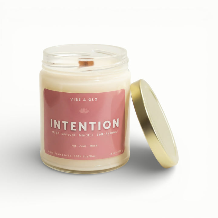 Vibe & Glo Intention soy candle in clear glass jar with wooden wick and gold lid, fig pear and musk fragrance