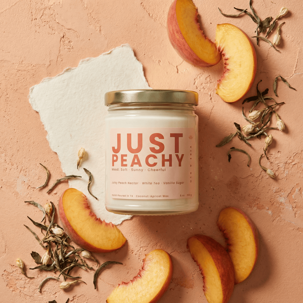 Just Peachy candle flat lay with sliced peaches and white tea leaves, fruity sweet scent with vanilla sugar in coconut apricot wax