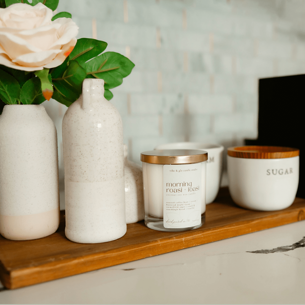 Morning Roast + Toast candle on a wooden shelf with decorative vases and sugar jar, enhancing cozy home decor.