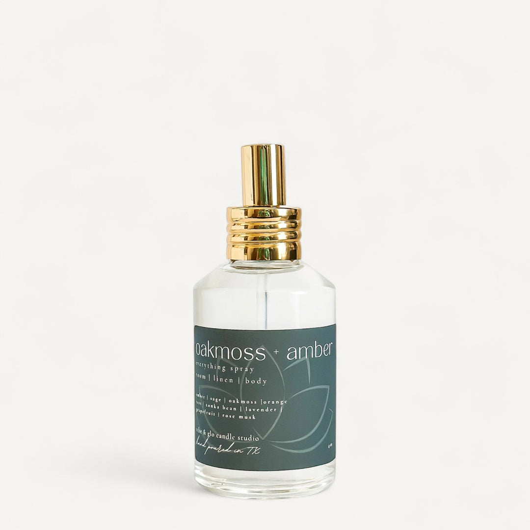 Oakmoss + Amber Room Spray bottle with golden cap, earthy fresh fragrance mist for home and body.