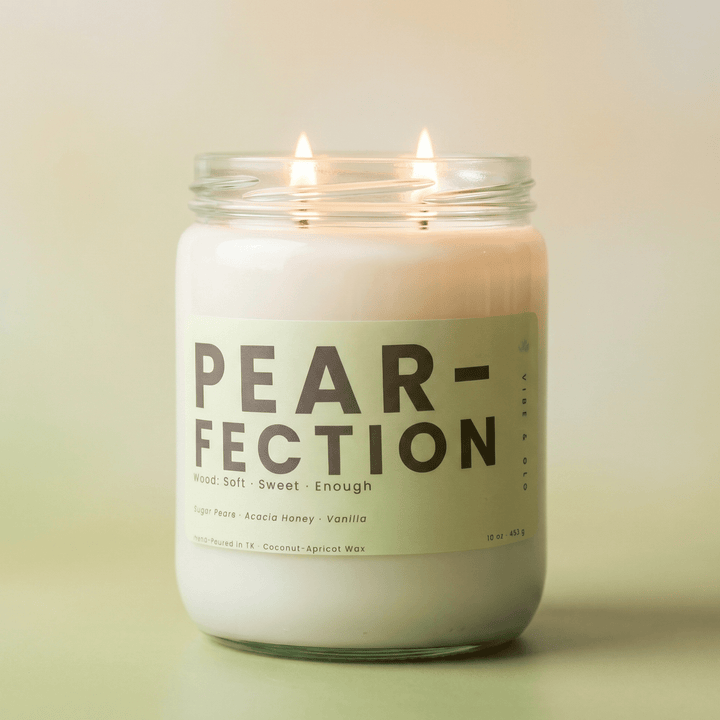 Pear-Fection 2-wick candle with soft glow on neutral background, sweet fresh pear scented candle