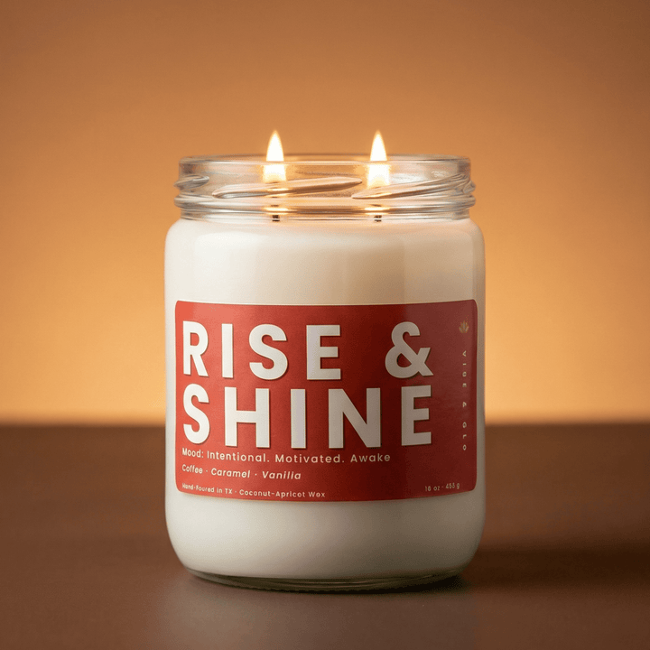 Rise and Shine 2-wick candle glowing on warm background, coffee caramel vanilla scented candle for cozy mornings
