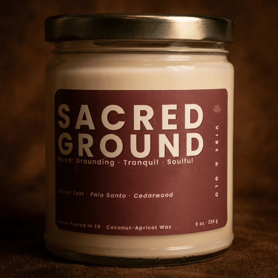 Close-up of Sacred Ground coconut apricot wax candle with palo santo and cedarwood scent in a warm moody setting
