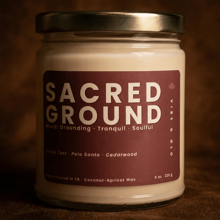 Close-up of Sacred Ground coconut apricot wax candle with palo santo and cedarwood scent in a warm moody setting
