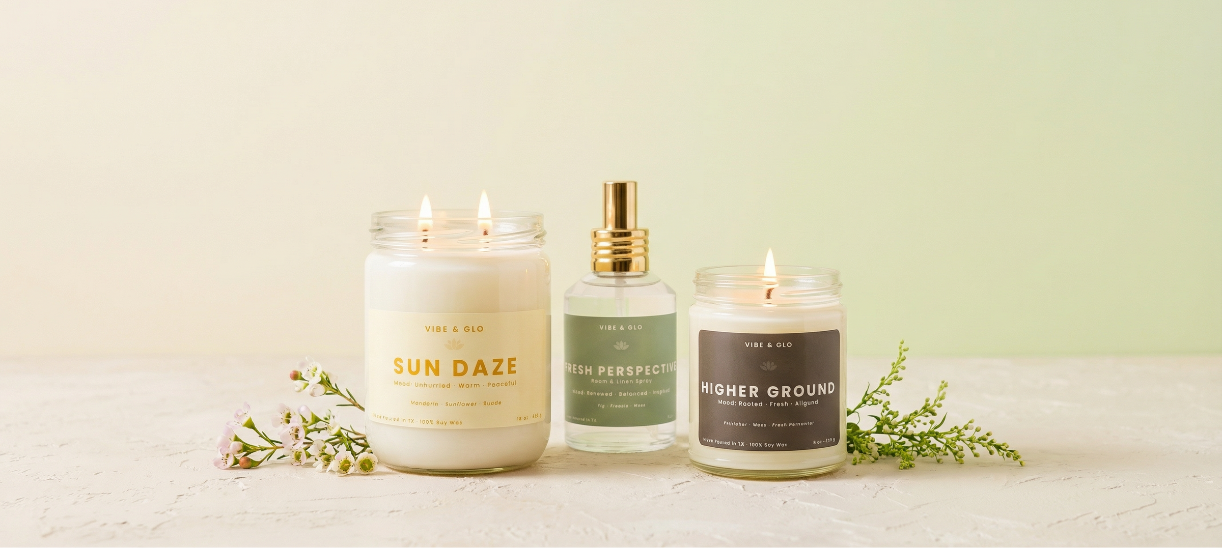 Spring home fragrance collection by Vibe & Glo featuring clean-burning soy candles and room & linen spray with citrus, floral, and fresh botanical scents.