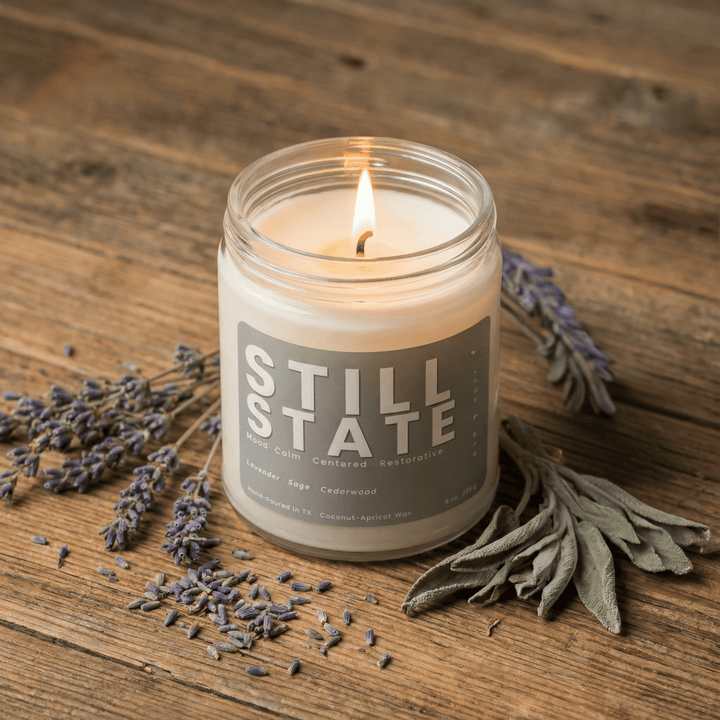 Still State candle with lavender and sage on a wood surface creating a calm spa-like home fragrance atmosphere