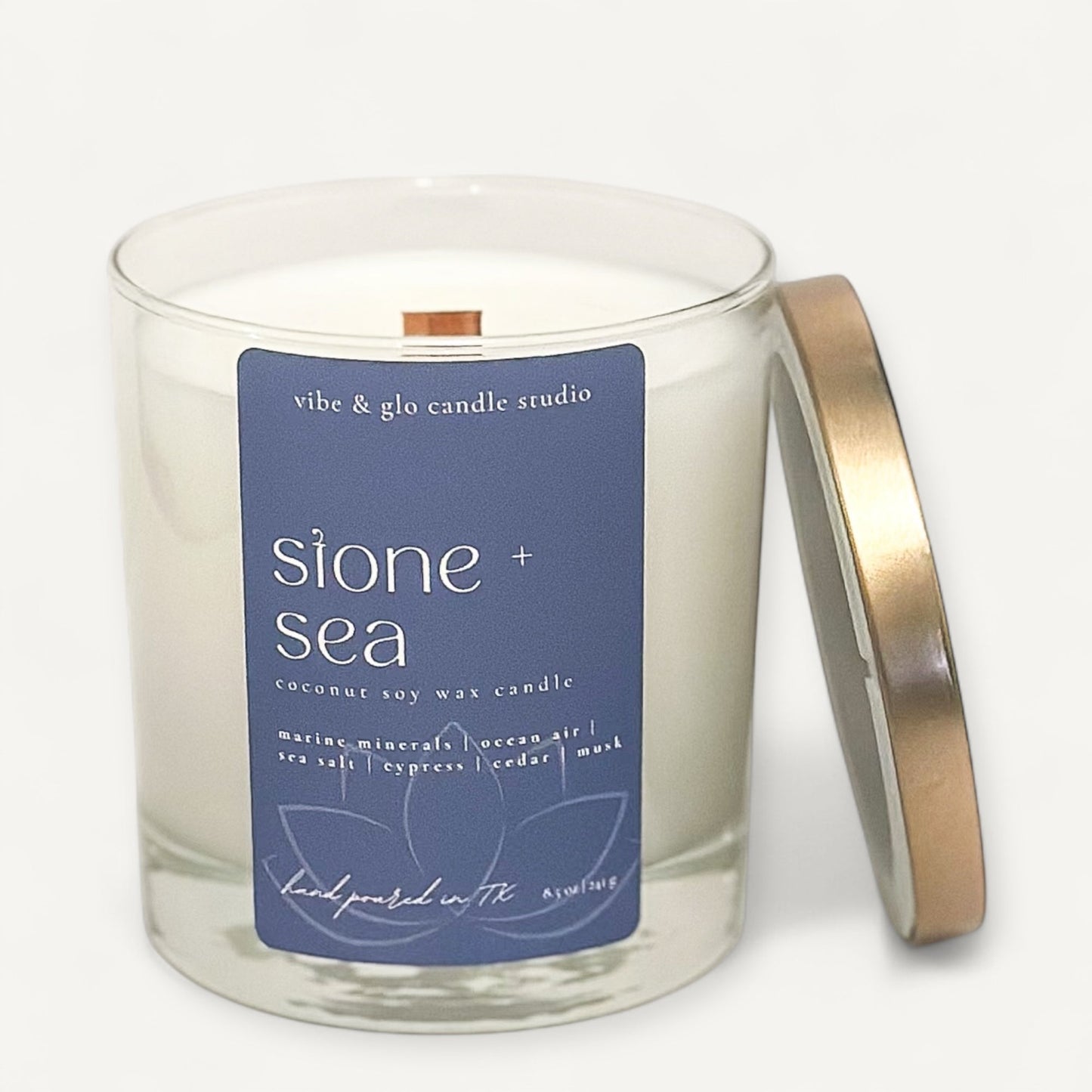 Stone and Sea candle by Vibe and Glo with coastal-inspired scent profile and blue label.