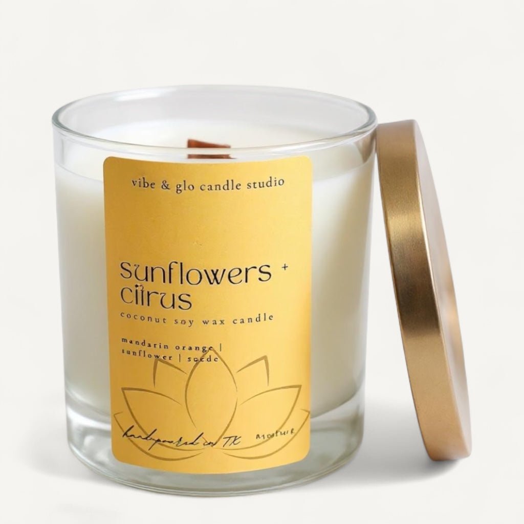 Vibe & Glo Sunflowers + Citrus coconut soy candle with mandarin orange, sunflower, and suede fragrance notes in a clear glass jar with gold lid.