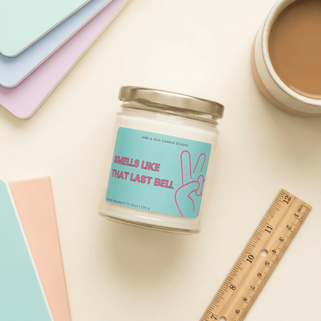 Teacher appreciation gift candle “Smells Like That Last Bell” styled with pastel notebooks and ruler – humorous 8 oz soy candle for teachers.