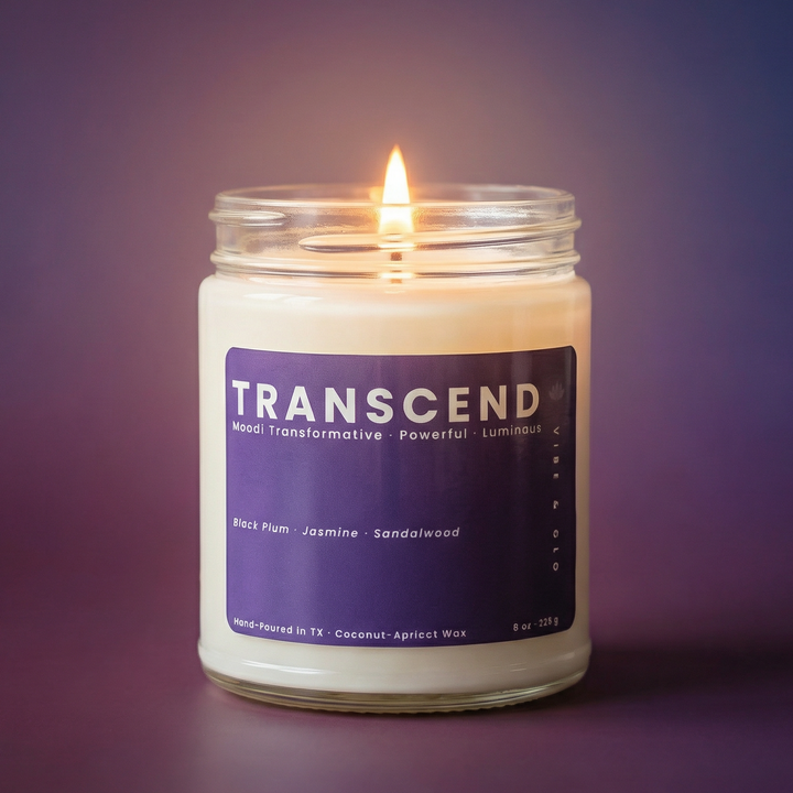 Lit Transcend candle glowing on purple gradient background, clean burning coconut apricot wax candle with black plum jasmine sandalwood scent