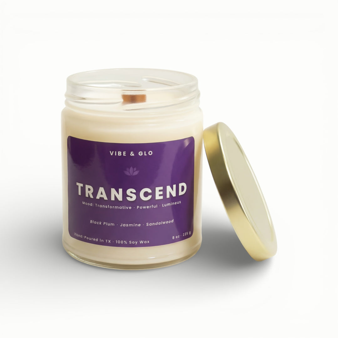 Vibe & Glo Transcend soy candle in clear glass jar with wooden wick and gold lid, black plum jasmine and sandalwood scent