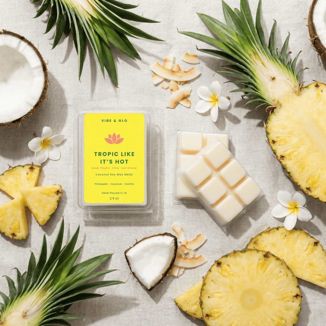 Tropic Like It’s Hot wax melts with pineapple slices and coconut pieces in bright tropical flatlay