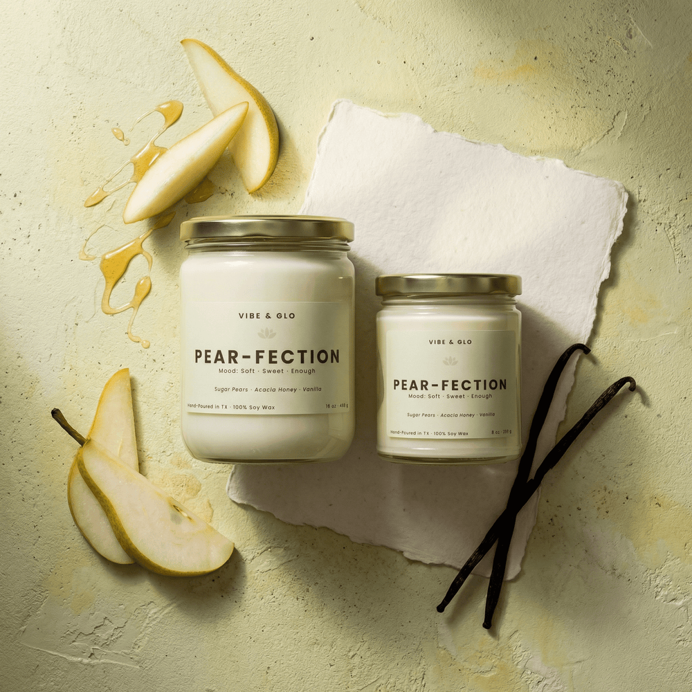 Pear-Fection pear and honey soy candles in 16 oz and 8 oz jars with gold lids, styled with sliced pears, honey drizzle, and vanilla beans on a light green backdrop.