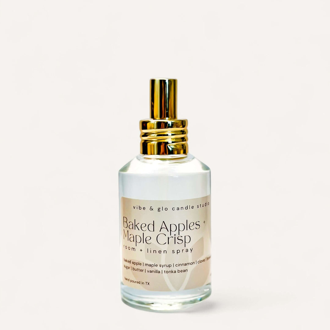 Baked Apples + Maple Crisp Room & Linen Spray bottle with golden cap on a white background.