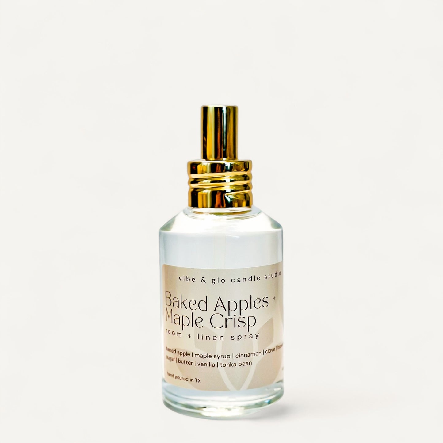 Baked Apples + Maple Crisp Room & Linen Spray bottle with golden cap on a white background.