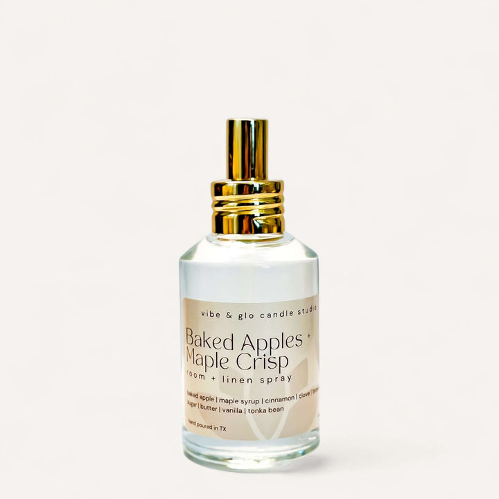 Baked Apples + Maple Crisp Room & Linen Spray bottle with golden cap on a white background.
