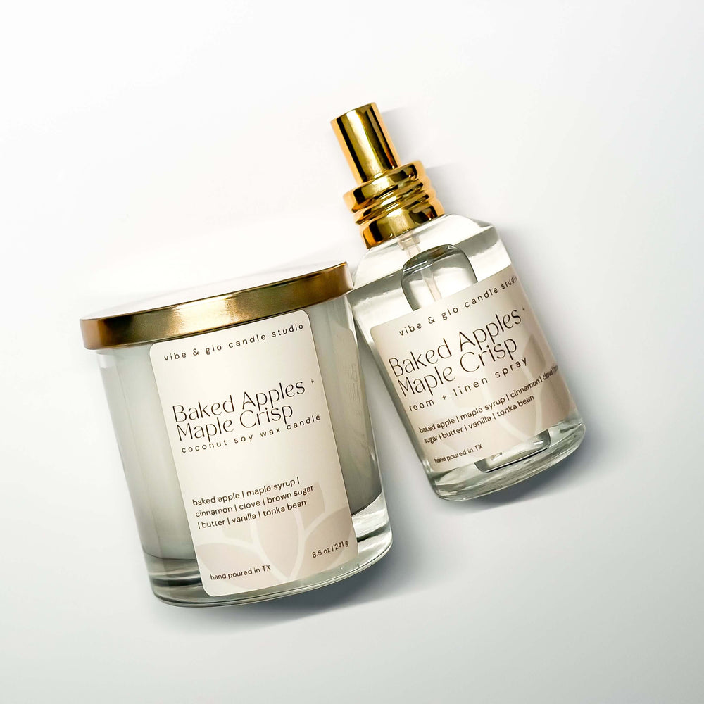 Candle and spray bottle with 'Baked Apples Maple Crisp' scent on a white background