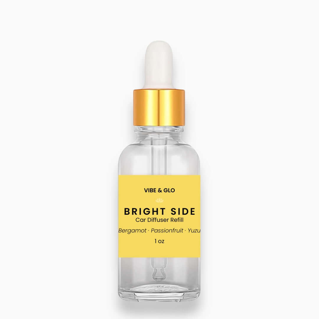 Vibe & Glo car diffuser refill bottle with yellow label on a white background