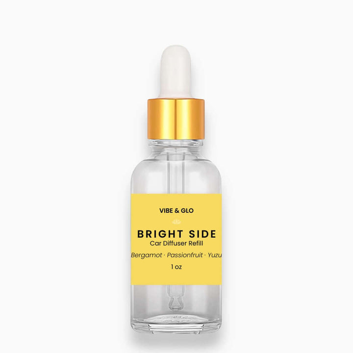 Vibe & Glo car diffuser refill bottle with yellow label on a white background