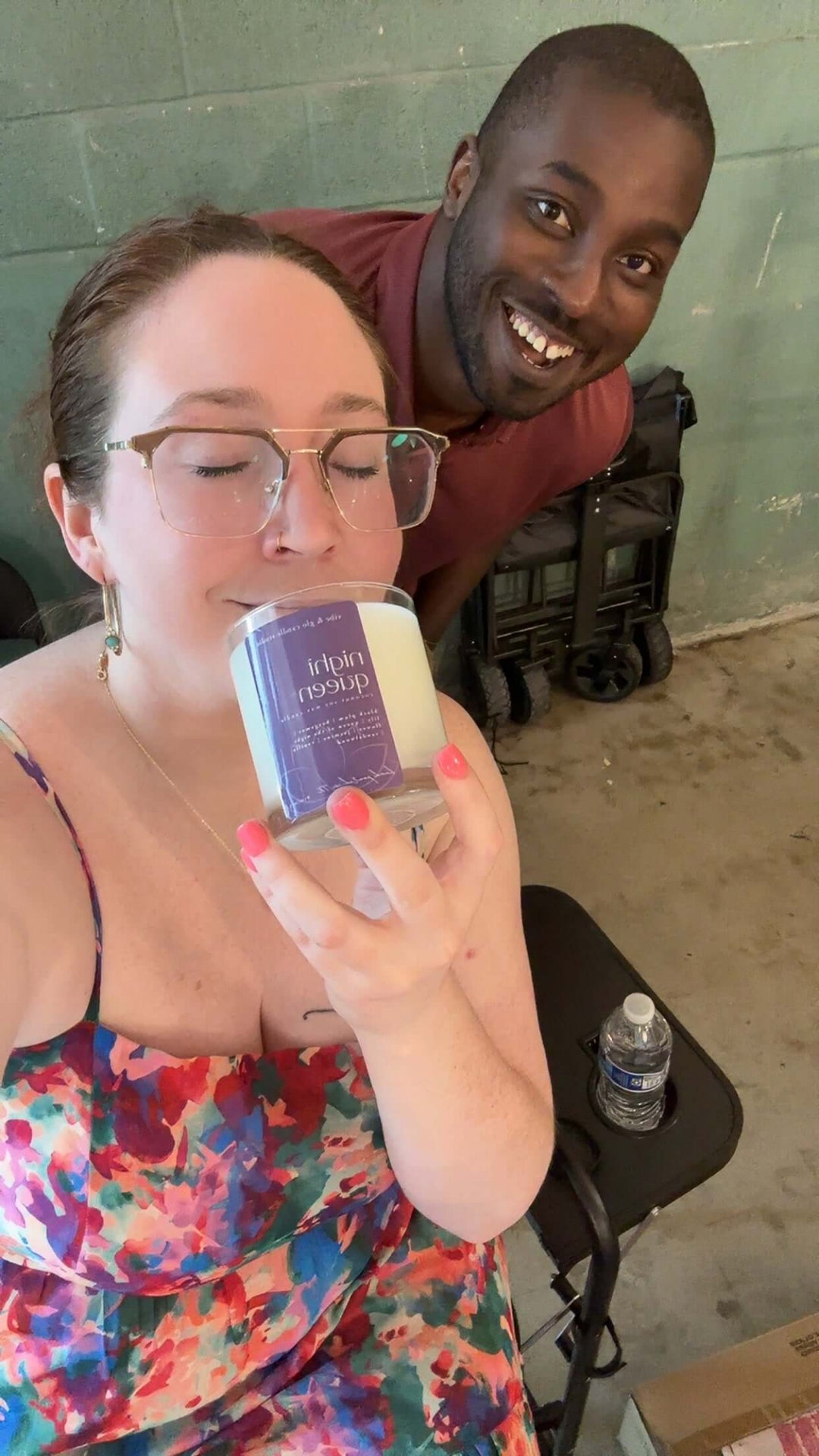 Two people, one holding a product packaging, in an indoor setting.